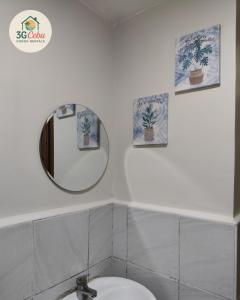 a bathroom with a mirror and a toilet at 3G Cebu Condo Rental in Lo-oc