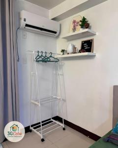 a shelf in a room with a refrigerator at 3G Cebu Condo Rental in Lo-oc +6 photos