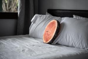 a wooden pillow sitting on top of a bed at Lumber Jill Lodge 16 Two Queen Room in Balsam Lake +19 photos