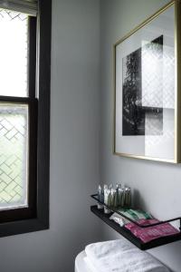 a room with a shelf and a picture and a window at Lumberjill Lodge 13 Double Queen Room in Balsam Lake