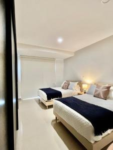 - 2 lits dans une chambre avec 2 lits dans l'établissement Departamento cerca del Malecón, à Mazatlán