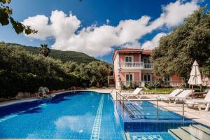 a villa with a swimming pool and a house at Kyprianos in Keri