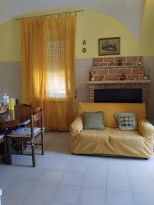 a living room with a couch and a table at La Locanda Del Re in Villalfonsina