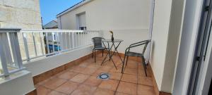 a balcony with two chairs and a table on the floor at Casa Saballa in O Grove