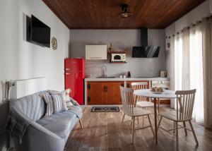 a living room with a couch and a table and a kitchen at Casa Anastacia Sykia in Sikia