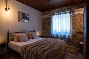 a bedroom with a large bed with a window at Casa Anastacia Sykia in Sikia +61 photos