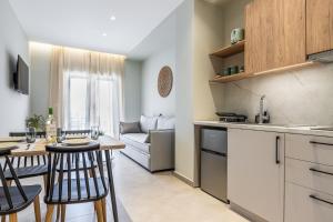 a kitchen and living room with a table and chairs at Seatherial Apartments Paleochora in Palaiochóra +19 photos