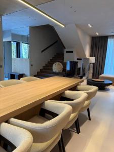 a dining room with a long wooden table and chairs at GirSki in Bukovel