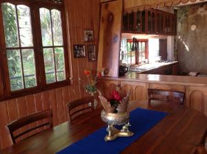 a kitchen with a table with a vase of flowers on it at HELFAROAN Spacious, Superb panoramic view! in Kandy