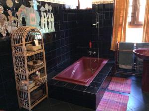 a bathroom with a red tub and a sink at HELFAROAN Spacious, Superb panoramic view! in Kandy +35 photos