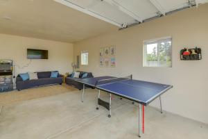 a ping pong table in a living room with a couch at Family-Friendly Florence Home 3 Mi to the Coast! in Florence