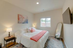 a white bedroom with a bed and a window at Family-Friendly Florence Home 3 Mi to the Coast! in Florence