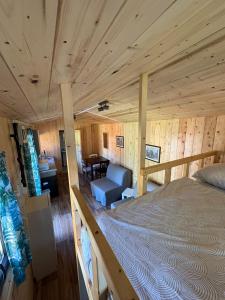 a bedroom with a large bed in a cabin at Sádky Lety in Lety