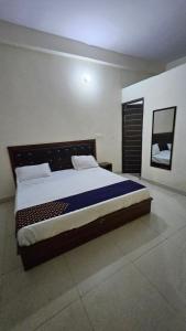 a bedroom with a large bed in a room at Hotel Village of village in Noida