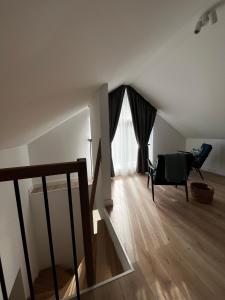 a living room with a chair and a window at Girios Horizontas - Mara in Trakai +25 photos