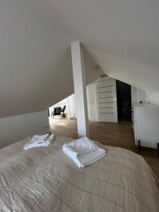 a bedroom with a large bed in a attic at Girios Horizontas - Mara in Trakai