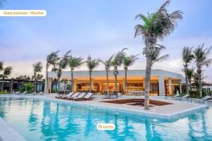 a swimming pool with palm trees in front of a building at Casa exclusiva com piscina no Origem Fortim in Maceio