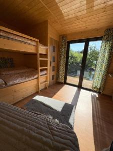 a bedroom with two bunk beds and a large window at Sádky Lety in Lety