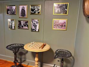 a room with a table and two chairs and pictures on the wall at Stylish 3BR with Patio Walk to State Capitol in Frankfort