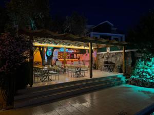 a patio with tables and chairs at night at Gold Monami Otel in Fethiye