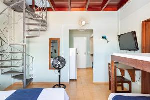 a room with a spiral staircase and a bedroom at Flat 208-A Vista Mar com Piscina in Cabo Frio