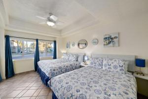 a bedroom with two beds and a window at Las Palmas 2BR 2BA Suite Ground Floor- D101 in Campo del Medio +49 photos