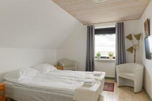 a bedroom with a white bed and a window at Branteviks Bed o Breakfast in Brantevik