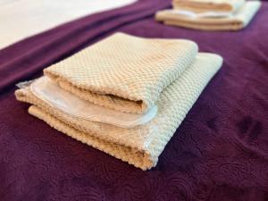 a stack of towels on top of a bed at SDD Brothers - Дом с балконом в сердце Тбилиси in Tbilisi City +37 photos