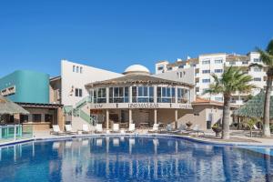 a large swimming pool in front of a building at Las Palmas 2BR 2BA Suite 3rd FL Ocean View- B301 in Campo del Medio