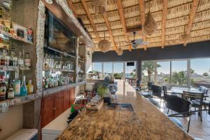 a bar with a large wooden counter in a restaurant at Las Palmas 2BR 2BA Suite 3rd FL Ocean View- B301 in Campo del Medio