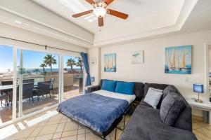 a living room with a couch and a ceiling fan at Las Palmas 2BR 2BA Suite 2nd FL Ocean View- G205 in Campo del Medio +55 photos