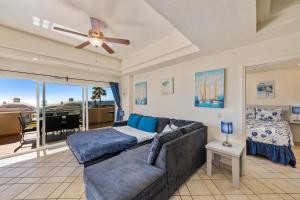 a living room with a couch and a ceiling fan at Las Palmas 2BR 2BA Suite 2nd FL Ocean View- G205 in Campo del Medio