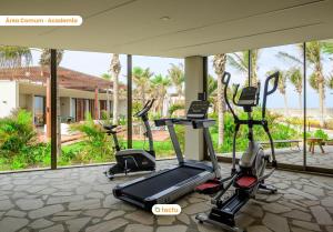 a gym with treadmills and ellipticals in a building at Casa luxo no Origem Fortim com piscina e jacuzzi in Maceio