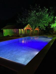 a large swimming pool lit up at night at KiDRAK OTEL MONTENEGRO-1 in Faralya