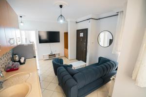 a living room with a couch and a tv at Downtown Bayrak Residences Trabzon in Trabzon