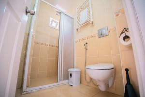 a bathroom with a toilet and a shower at Downtown Bayrak Residences Trabzon in Trabzon +19 photos