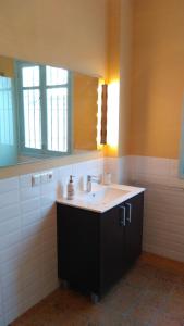 a bathroom with a sink and a mirror at Ca Bienvenida in Miramar