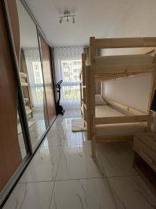 a hallway with bunk beds in a room at Apartament Dobrzec in Kalisz