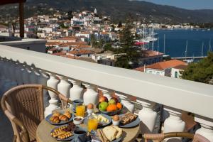 a table with plates of food on a balcony at Dimitra Boutique Hotel in Poros