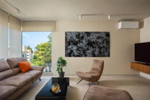 a living room with a couch and a tv at Maneo Lux in Poreč