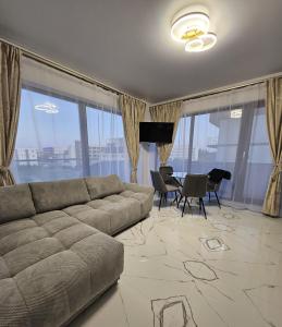 a living room with a couch and a dining room at EverGreen Apartment4 in Năvodari