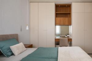 a bedroom with a bed and a desk at Maneo Lux in Poreč