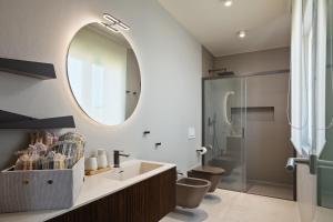 a bathroom with a sink and a mirror at Maneo Lux in Poreč +47 photos