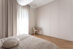 a bedroom with a bed with a pillow on it at Leśne spa przy Sopocie in Gdynia