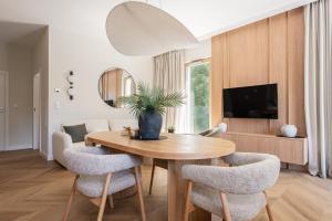 a dining room with a wooden table and chairs at Leśne spa przy Sopocie in Gdynia