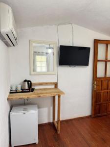 a room with a table and a television on a wall at KiDRAK OTEL MONTENEGRO-1 in Faralya