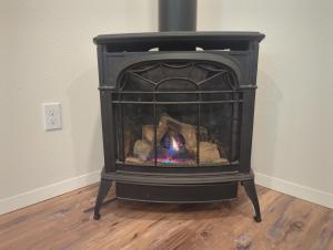 a black stove in the corner of a room at Eagle Cap Chalets in Joseph