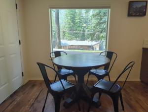 a table and chairs in a room with a window at Eagle Cap Chalets in Joseph