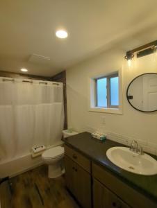 a bathroom with a sink and a toilet and a mirror at Eagle Cap Chalets in Joseph