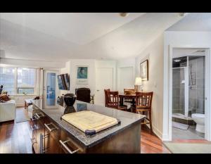 a kitchen and living room with a counter top at Core Downtown Toronto-8 Sleeper-4 Beds-2 Bathrooms-Washrooms-Free Parking-CN Tower-Ripleys Museum-Blue Jays Stadium In front-Indoor Gym-Swimming Pool-Jacuzzi Sauna-Filter Drinking Water-WiFi in Toronto +69 photos